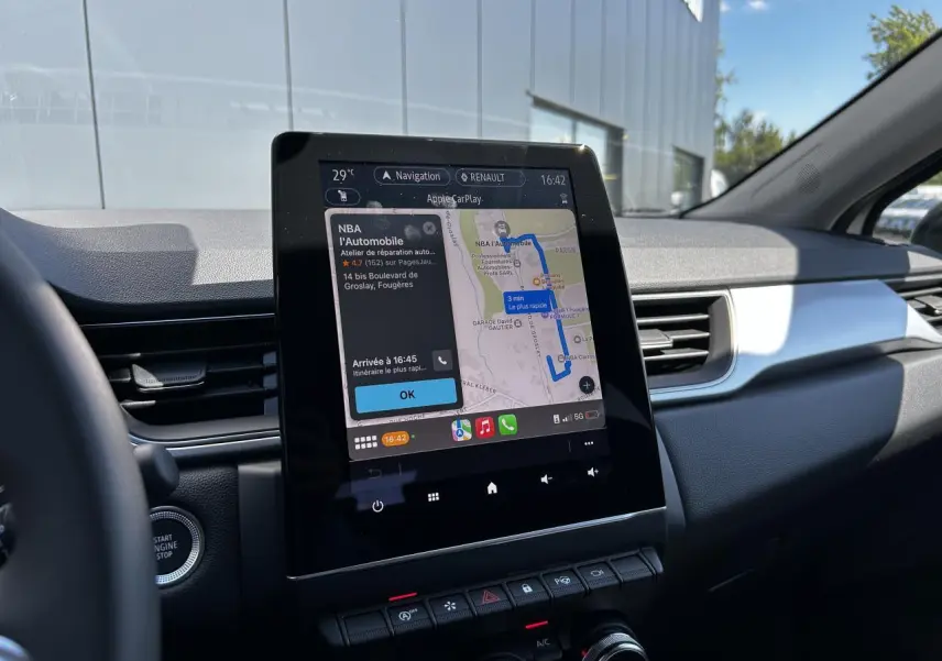 Vue intérieure du tableau de bord du Renault Captur 2024 avec écran tactile 9,3'' affichant la navigation Apple CarPlay.