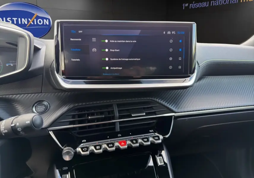 Intérieur du tableau de bord du Peugeot 2008 Hybrid 145 e-DCS6 GT avec écran tactile central et commandes piano noires.