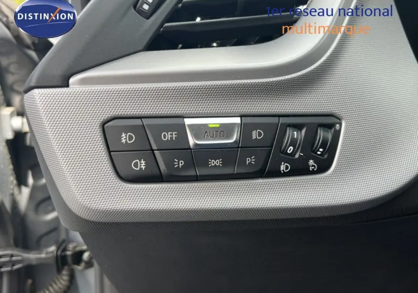 Détail des commandes de lève-vitres et réglage des rétroviseurs sur la porte côté gauche d’une BMW Série 1 gris mat.