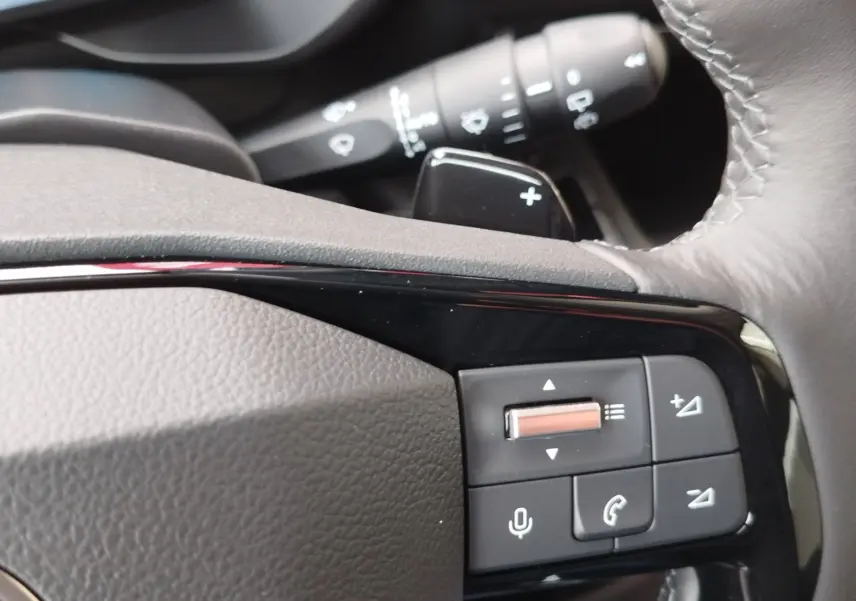 Gros plan sur les commandes du volant gris foncé du Citroën Berlingo 2026, avec molette et boutons multifonctions.