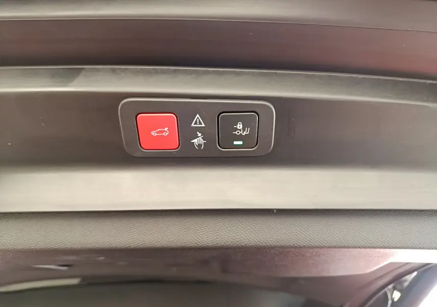 Boutons de commande rouge et noir sur le hayon intérieur du coffre du Peugeot 5008 bleu 2021.