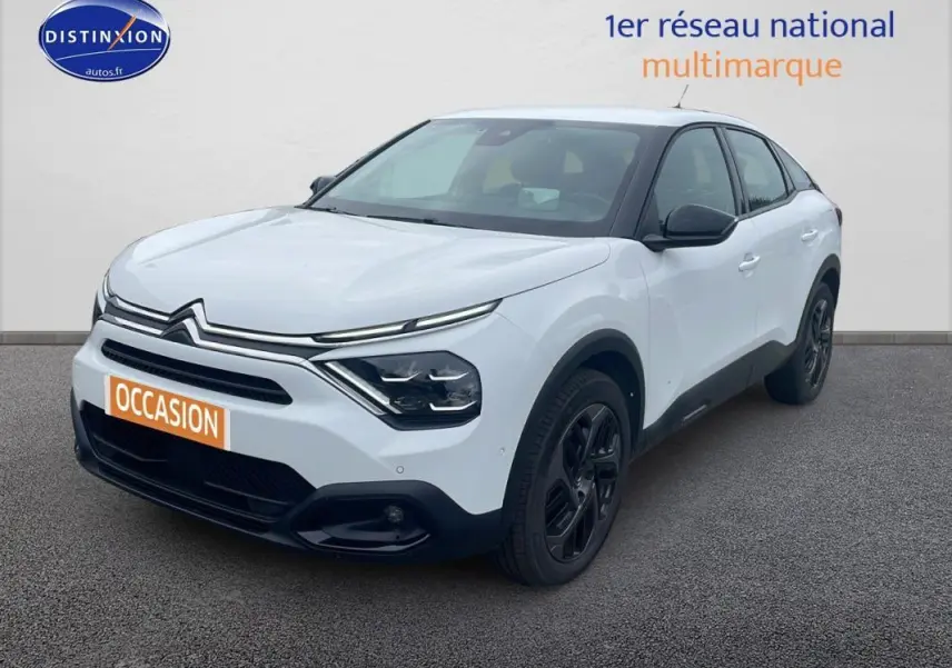 Citroën C4 blanc vue 3/4 avant droit avec jantes alliage noires et calandre distinctive moderne.