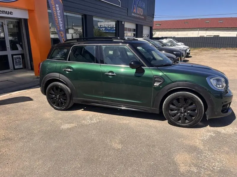 Vue de profil côté gauche d'une MINI Countryman Cooper D 2018 en British Racing Green avec jantes noires et toit noir.