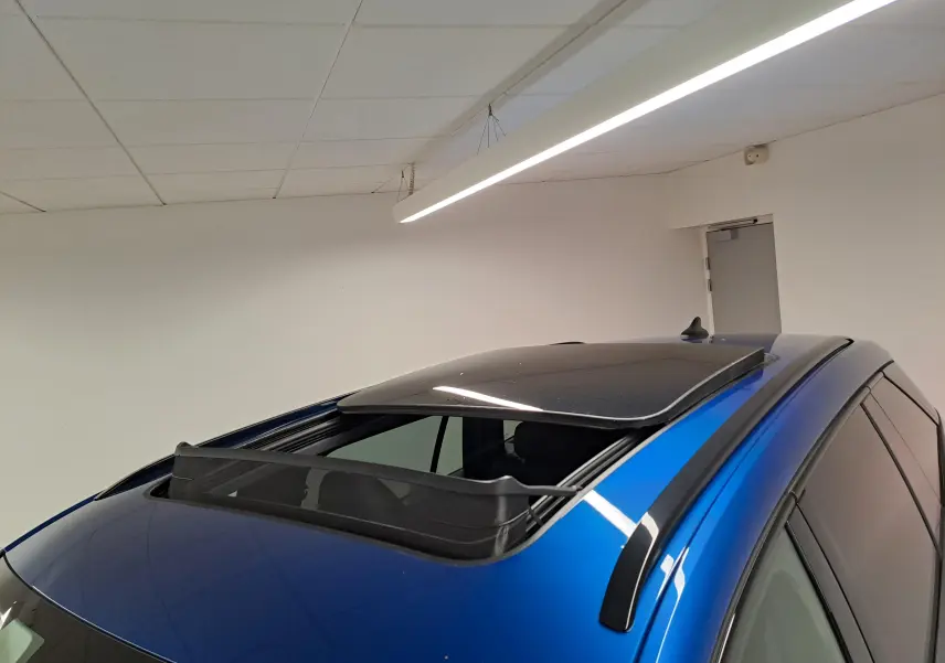 Vue rapprochée du toit panoramique ouvrant électrique en verre du Skoda Kodiaq Bleu RS 2025, côté gauche.