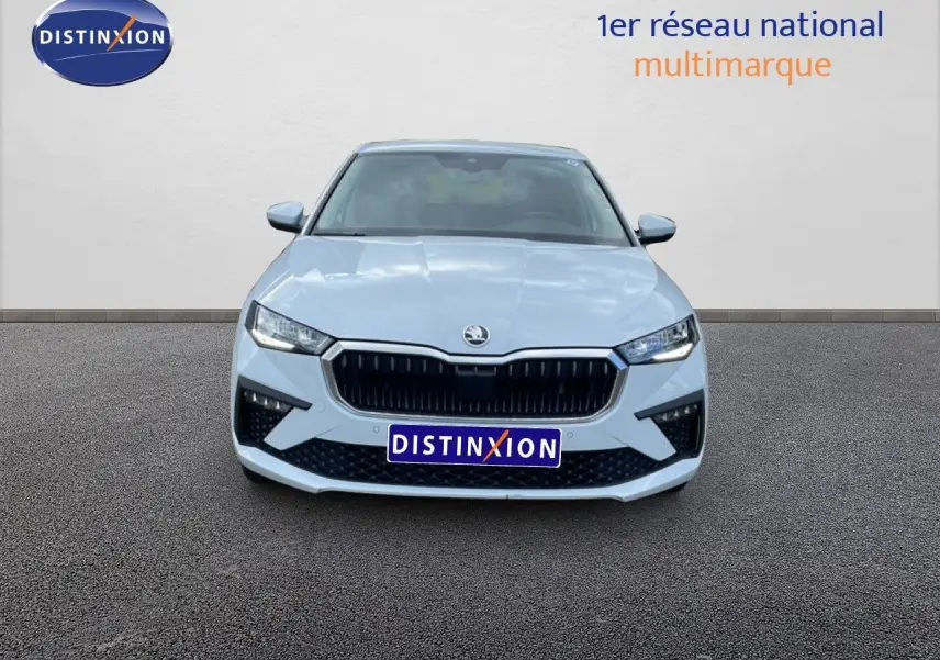 Vue frontale d'une Skoda Scala blanc glacier avec calandre noire et phares LED allumés.