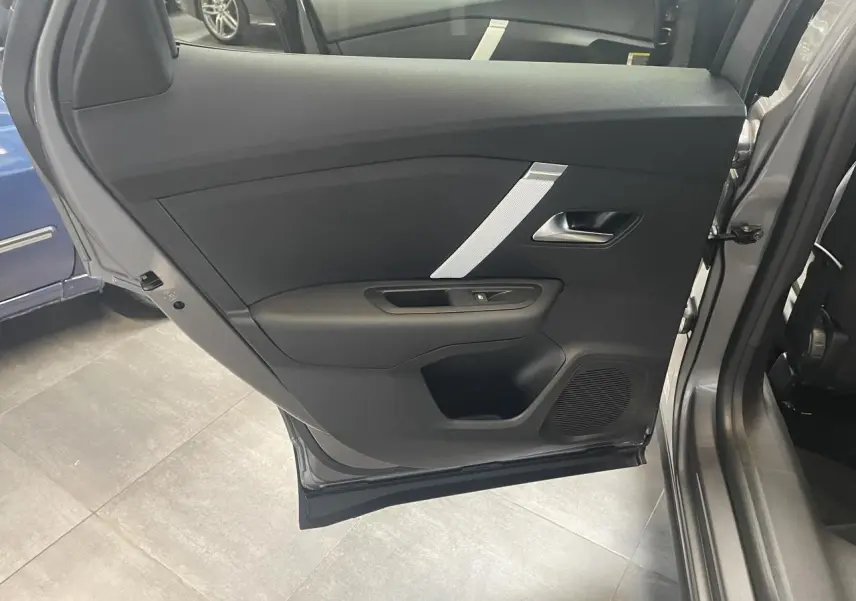 Vue intérieure de la porte arrière droite grise de la Citroën C4 avec garniture noire et insert argenté.