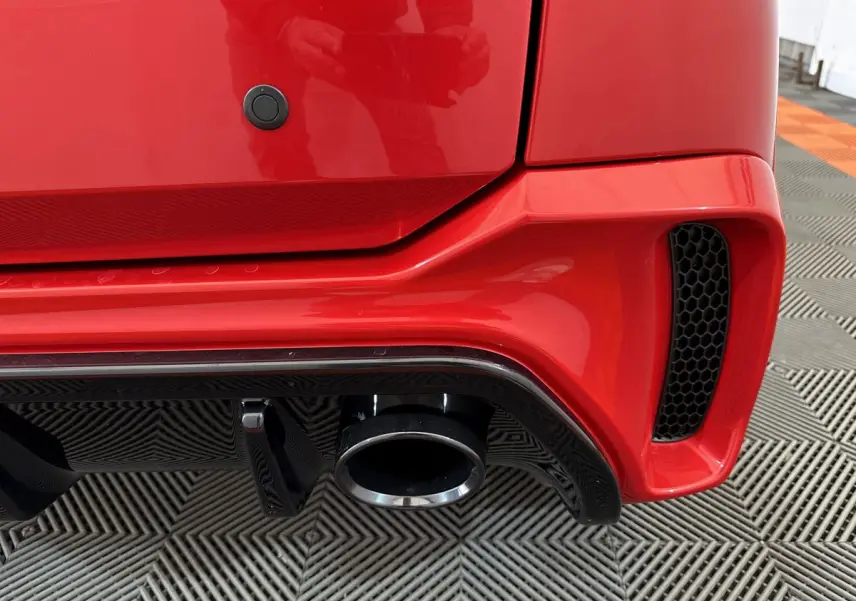 Gros plan sur l'échappement et le diffuseur arrière rouge vif de l'AIXAM AMBITION 0.5 CITY COUPE GTI E5+ 2025.