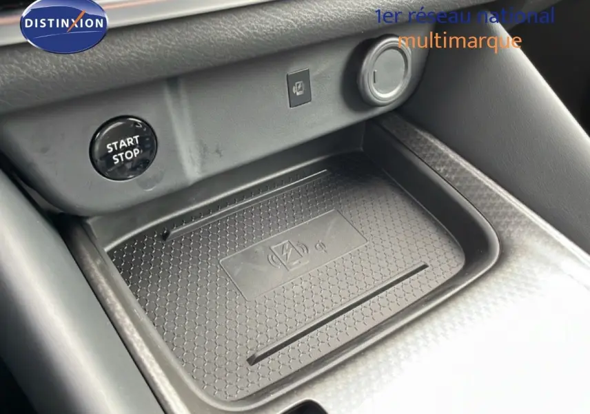 Détail de la console centrale noire avec bouton start/stop et zone de charge sans fil du Nissan Qashqai 2025.