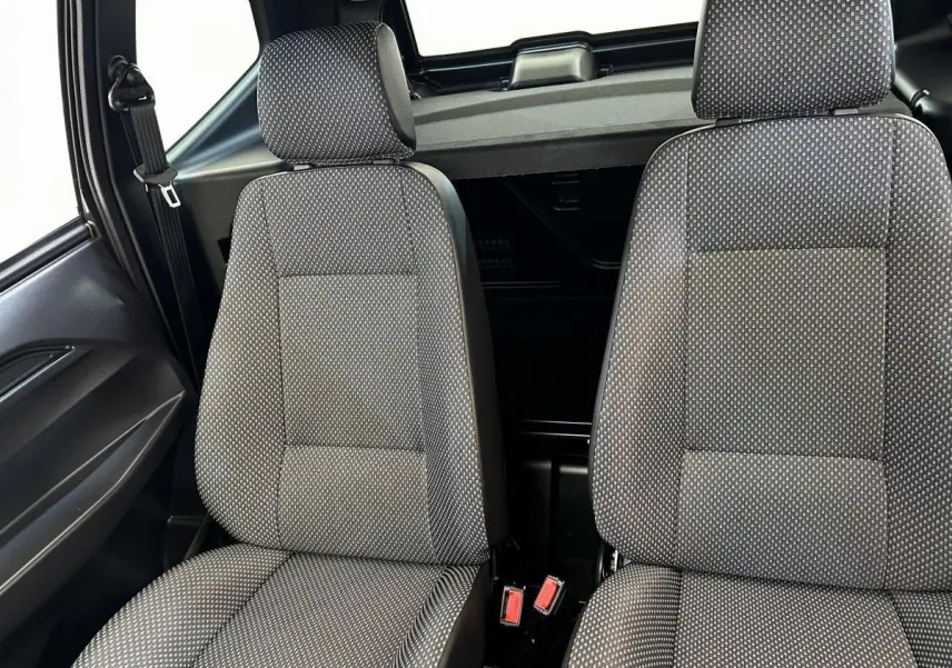 Intérieur montrant les sièges avant gris à motifs de l'AIXAM AMBITION 0.5 CITY PACK 2025, vue rapprochée côté conducteur.