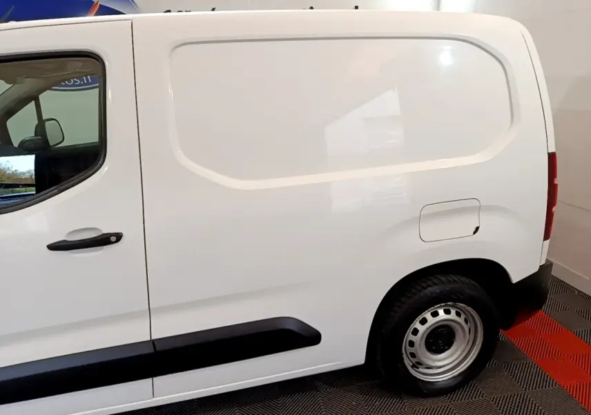 Vue latérale droite d'un utilitaire Citroën Berlingo blanc avec cloison pleine et jantes acier simples.