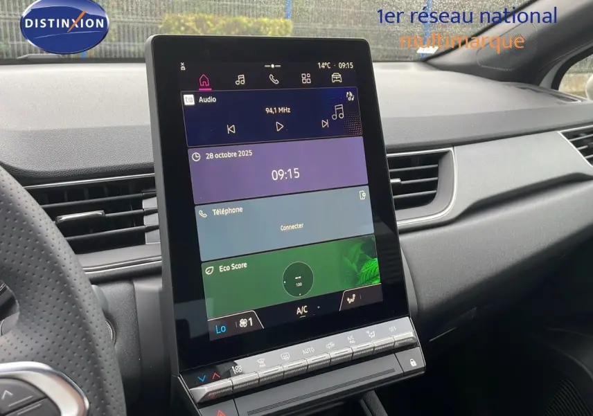 Vue intérieure du tableau de bord du Renault Captur E-Tech 2025 avec écran tactile central et volant partiel en cuir perforé.