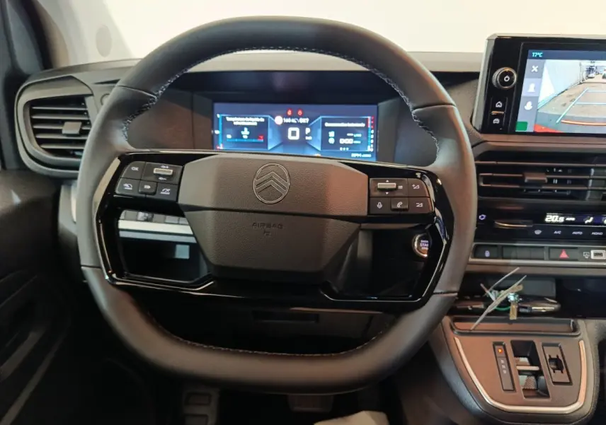 Vue intérieure centrée sur le volant noir du Citroën Jumpy 2025 avec tableau de bord digital et écran multimédia.
