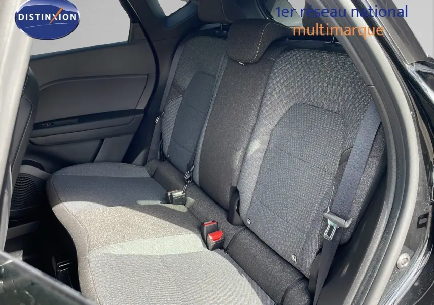 Vue intérieure montrant la banquette arrière en tissu gris du Renault Captur E-Tech hybride 2025, porte arrière ouverte.