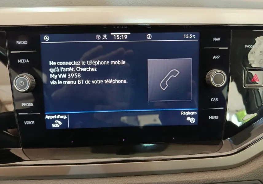 Écran tactile central du tableau de bord de la Volkswagen Polo blanche, affichant les options Bluetooth et téléphone.