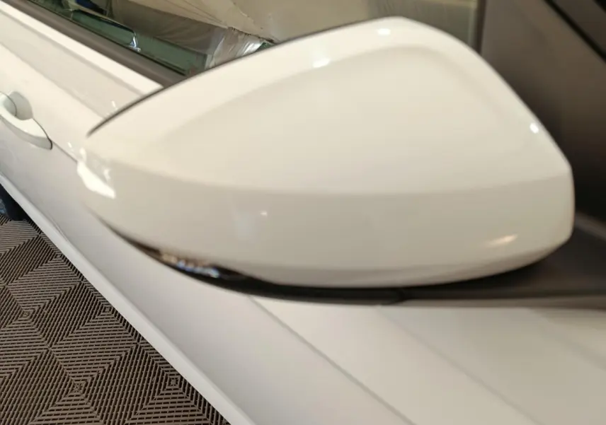 Gros plan sur le rétroviseur côté gauche blanc de la Volkswagen Polo 1.0 TSI 95 Lounge Business 2020.