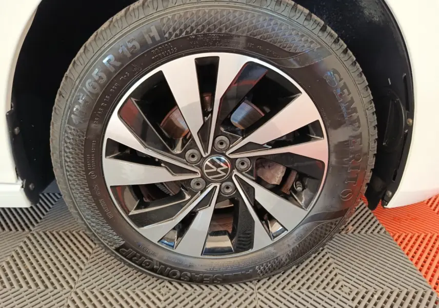 Gros plan sur la roue avant droite blanche d'une Volkswagen Polo 1.0 TSI 95 Lounge Business avec jante alliage noir et argent.