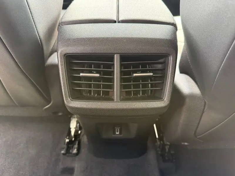 Vue rapprochée des aérateurs arrière noirs et prise USB du Citroën C5 Aircross 2025, intérieur gris foncé.