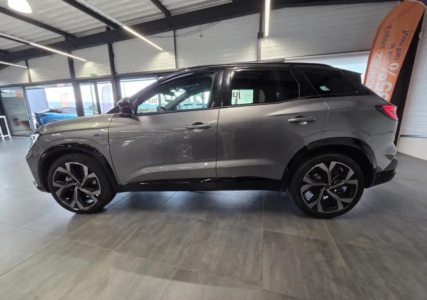 Profil droit du Renault Austral 2024 gris foncé avec toit noir étoilé et jantes alliage 20 pouces diamantées.