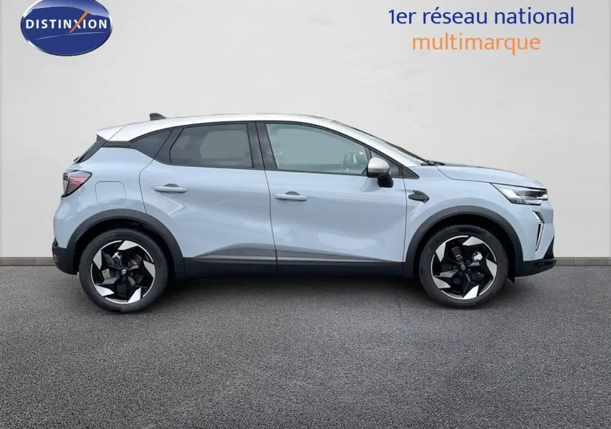 Profil côté gauche du Renault Captur E-Tech hybride gris rafale métal avec toit beige et jantes noires 2025.