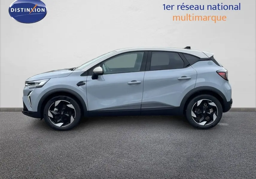 Profil droit du Renault Captur E-Tech hybride 2025 gris rafale avec toit beige et jantes noires.