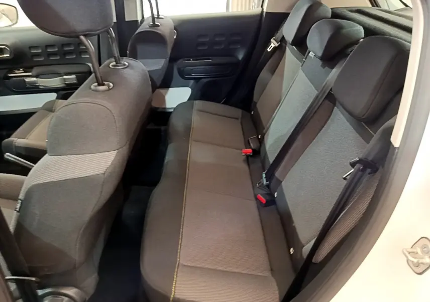 Vue intérieure côté droit montrant la banquette arrière grise de la Citroën C3 blanche de 2019.