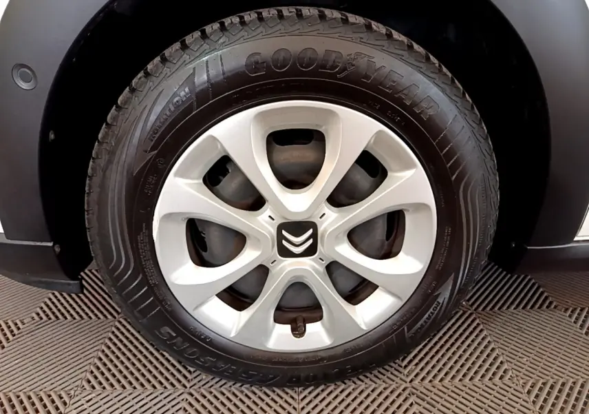 Gros plan sur la roue avant gauche de la Citroën C3 blanche, avec jante alliage et pneu Goodyear visible.