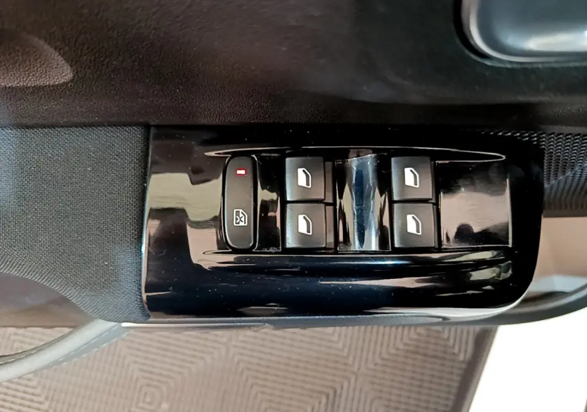 Gros plan sur les commandes de lève-vitres électriques côté conducteur d'une Citroën C3 blanche de 2019.