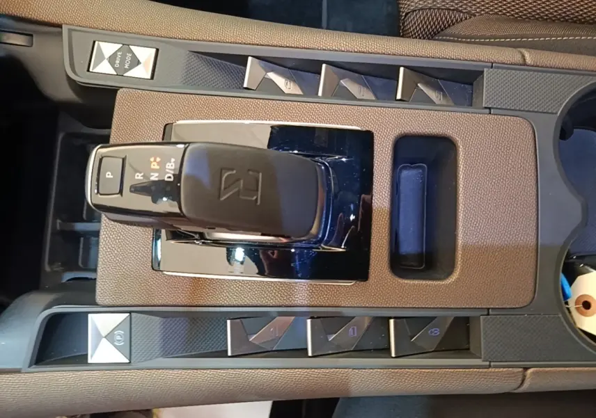Vue rapprochée de la console centrale du DS7 Crossback E-TENSE 225, montrant le levier de vitesses et les boutons de commande.
