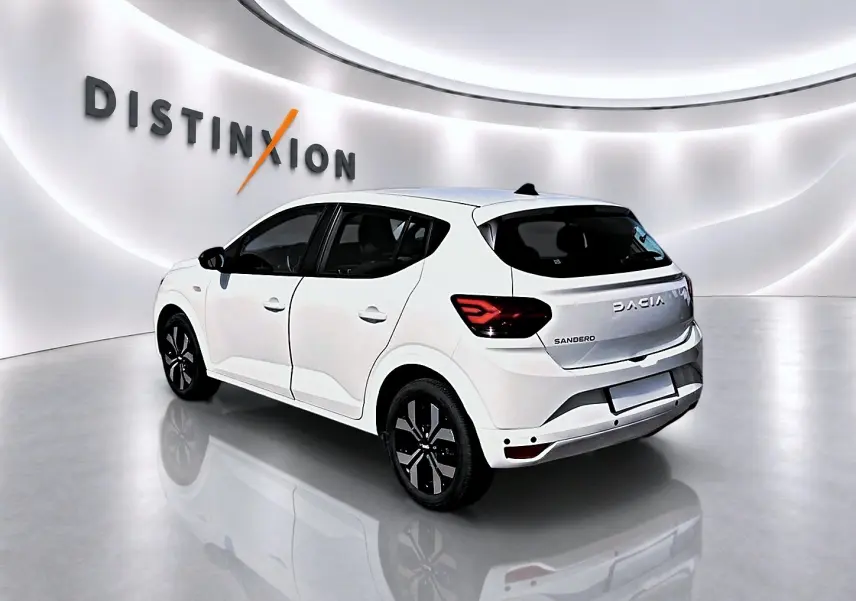 Vue 3/4 arrière droite d'une Dacia Sandero blanche 2025 avec jantes alliage et feux arrière LED distinctifs.