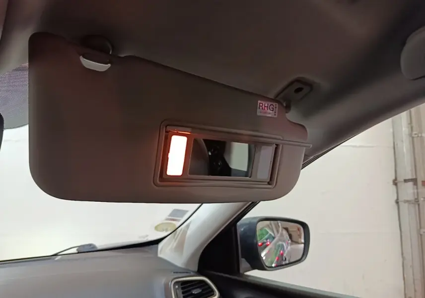 Détail intérieur du pare-soleil avec miroir éclairé côté conducteur du Renault Kadjar gris foncé, vue vers la portière.