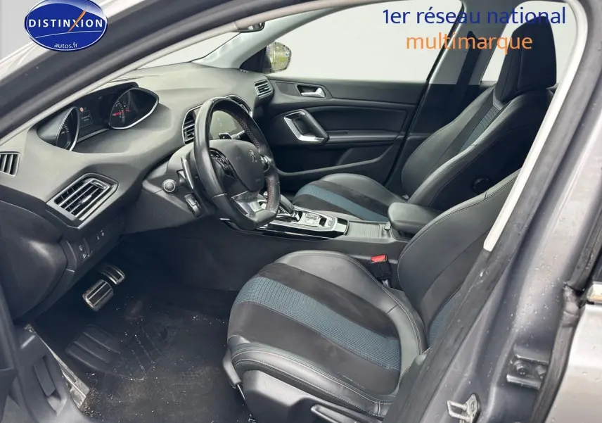 Intérieur avant droit de la Peugeot 308 gris Artense 2019, montrant sièges sport et tableau de bord moderne.