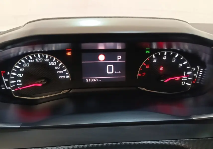 Vue rapprochée du tableau de bord numérique de la Peugeot 2008, affichant la vitesse à 0 km/h et le compteur kilométrique.