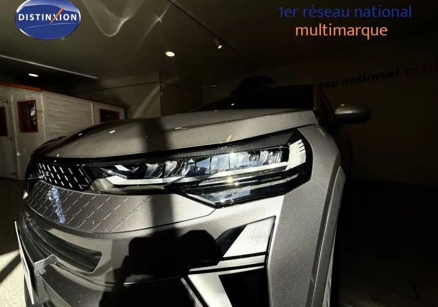 Gros plan sur l'avant droit du Renault Captur gris Cassiopée métal, mettant en valeur son phare LED moderne.