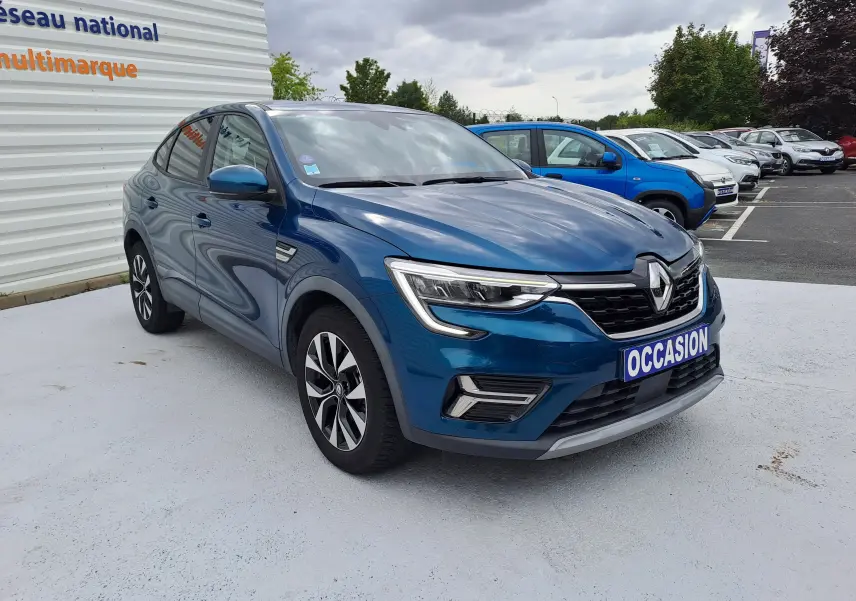 Renault Arkana bleu Zanzibar métal en 3/4 avant droit avec calandre marquée et jantes alliage bicolores.