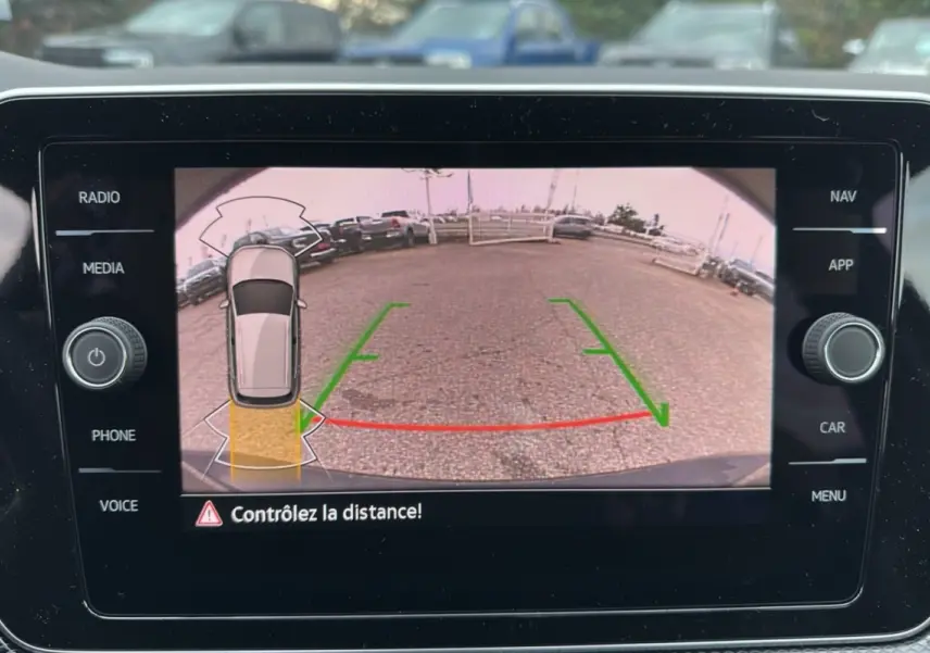 Écran de caméra de recul du Volkswagen T-Cross noir intense, affichant les lignes de guidage et l'alerte de distance.