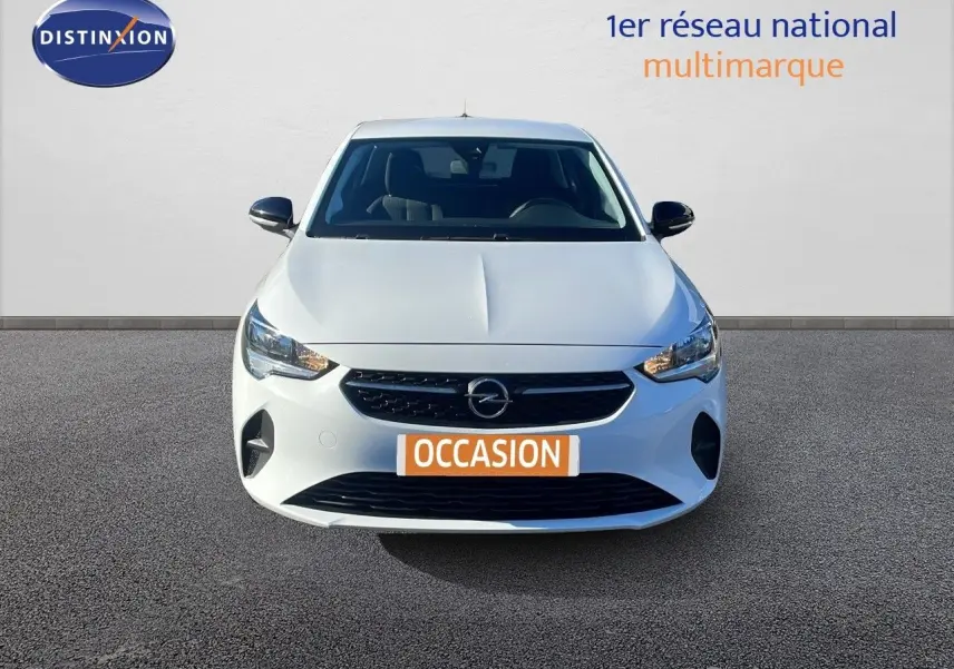 Vue frontale d'une Opel Corsa blanche glacier 2022 avec calandre noire et phares allumés sur fond neutre.