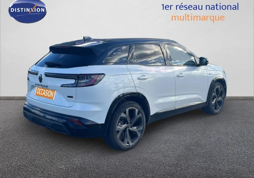 Vue 3/4 arrière droite du Renault Austral Iconic Esprit Alpine blanc et noir avec jantes foncées sur sol gris.