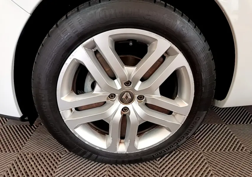 Gros plan sur la roue avant droite d'une Renault Clio Business TCe 90 blanche avec jante alliage à 5 branches doubles.