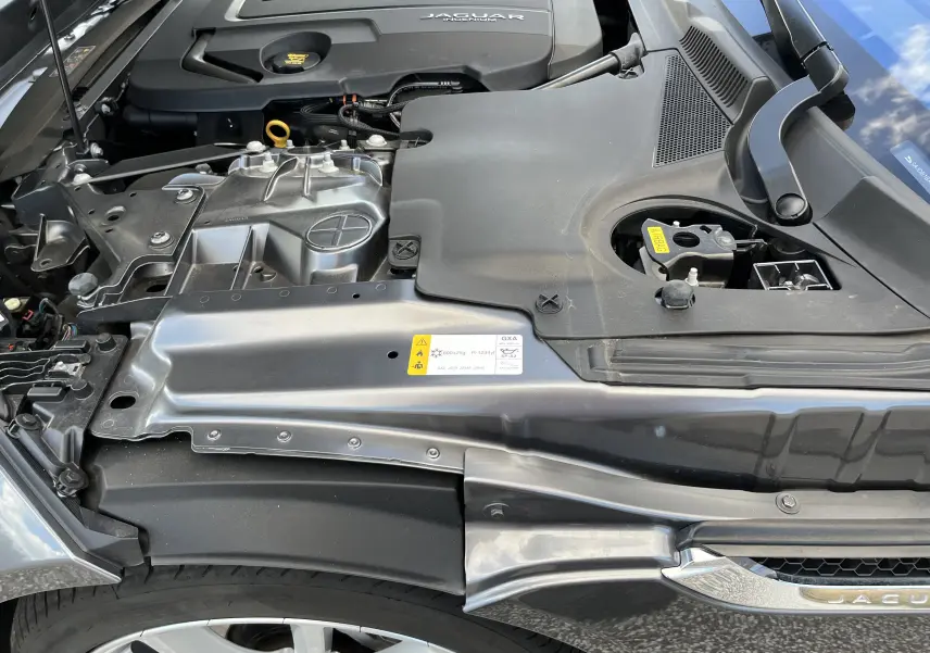 Vue rapprochée du compartiment moteur de la Jaguar F-TYPE II Coupé 2.0T 2018 en gris Corris, avec détails du capot ouvert.