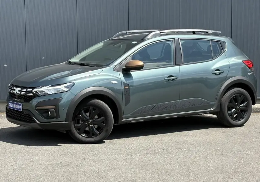 Vue de profil côté gauche d'une Dacia Sandero Stepway Vert Cèdre avec jantes noires et coques de rétroviseurs cuivrées.