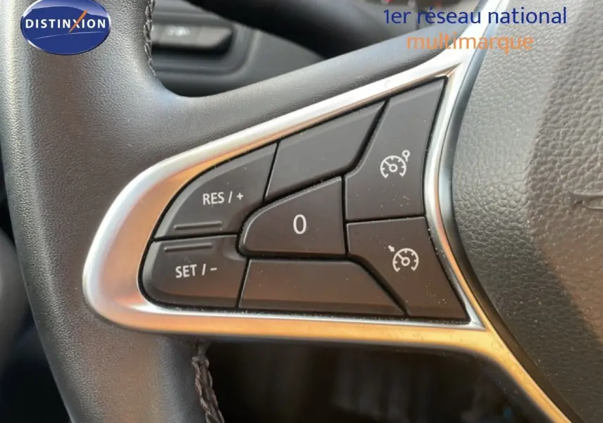 Gros plan sur les commandes au volant gauche d’une Renault Clio blanche glacier, version Business 2020.