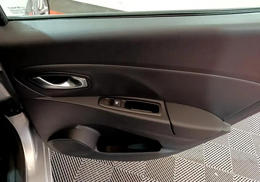 Porte intérieure côté gauche de Renault Clio Business TCe 90 gris clair, avec poignée argentée et commande de vitre électrique.