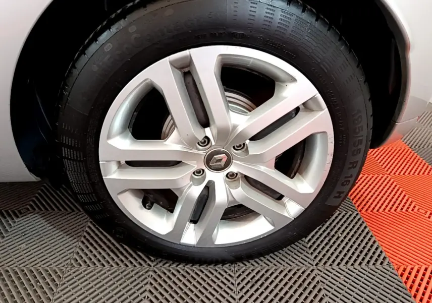 Gros plan sur la roue avant droite gris clair de la Renault Clio Business TCe 90 avec jante alliage à 5 branches.