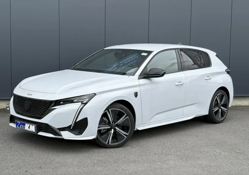 Peugeot 308 blanc Okenite vue 3/4 avant droit avec jantes alliage 18'' diamantées et calandre noire distinctive.