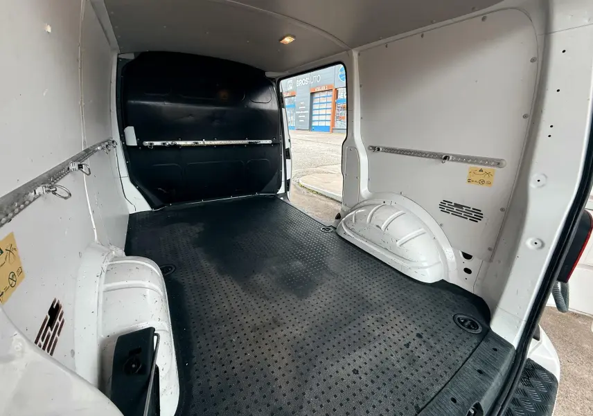 Vue intérieure arrière du Volkswagen Transporter blanc L1H1 2018, montrant l’espace de chargement avec sol antidérapant noir.