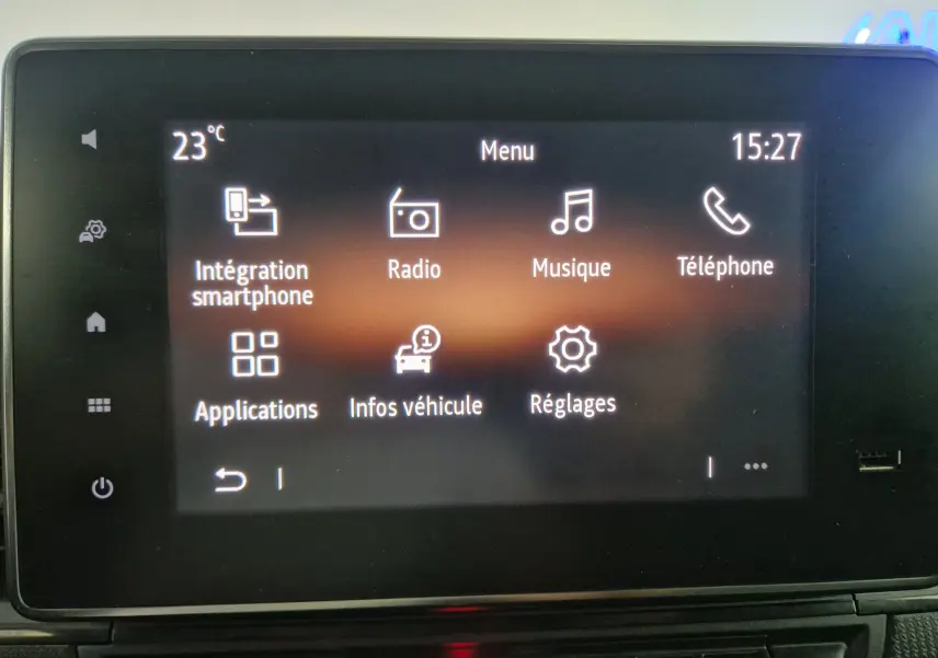 Écran tactile central du Renault Kangoo blanc 2023 affichant le menu principal avec options multimédia et réglages.