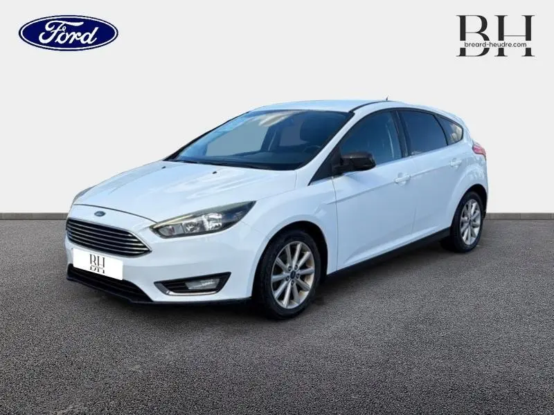 Ford Focus blanc Glacier vue 3/4 avant droit avec calandre chromée et jantes alliage.