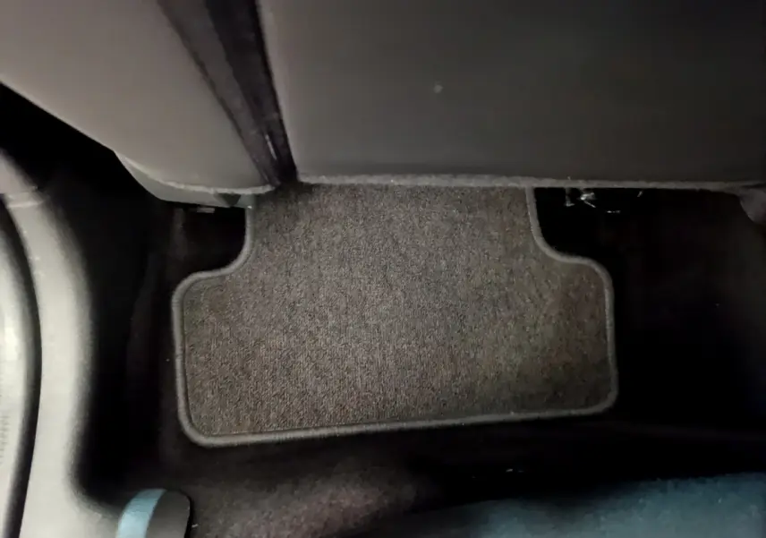 Tapis de sol gris foncé côté passager arrière dans l'habitacle d'une Renault Clio Business blanche de 2019.