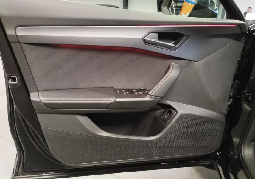 Contre-porte côté gauche noir suédine avec surpiqûres cuivrées et bandeau lumineux rouge du CUPRA Formentor 2026.