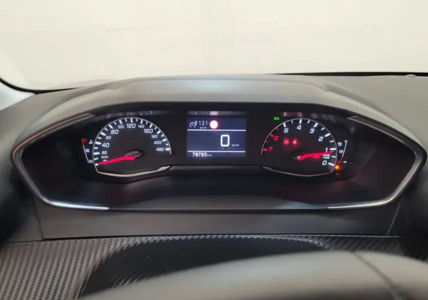 Tableau de bord de Peugeot 208 gris foncé 2023, affichage numérique central et compte-tours analogique rouge.